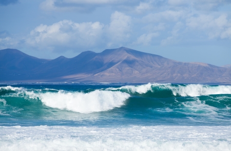 Sea swell between Fuerteventura and Lanzarote - Playa blanca area of Lanzarote in the backgroundの写真素材
