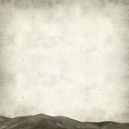 textured old paper background with outline of a mountain rangeの写真素材