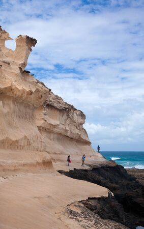 Eroded  west coast of Fuerteventura at Jandia, close to La Pared, group of walkers on the coastal pathのeditorial素材