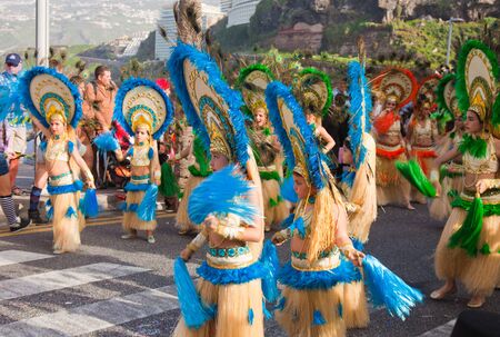 PUERTO DE LA CRUZ, SPAIN - February 16: Colorfully dressed participants take part in main carnival parade on February 16, 2013 in Puerto de la Cruz, Tenerife, Spainのeditorial素材