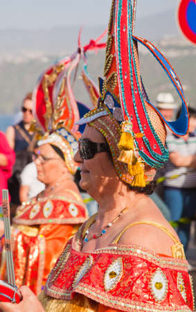 PUERTO DE LA CRUZ, SPAIN - February 16: Colorfully dressed participants take part in main carnival parade on February 16, 2013 in Puerto de la Cruz, Tenerife, Spainのeditorial素材