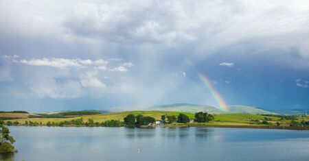 rainbow over lakeの写真素材