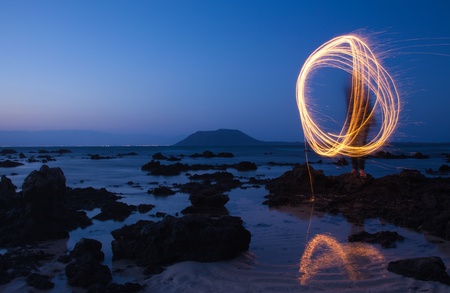 complicated figure drawn by a sparkler stick in the airの写真素材