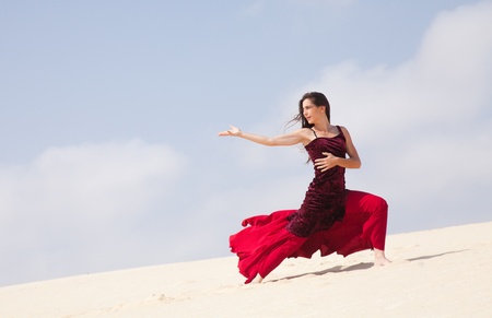 Flamenco dancer in the long dress in the dunesの写真素材