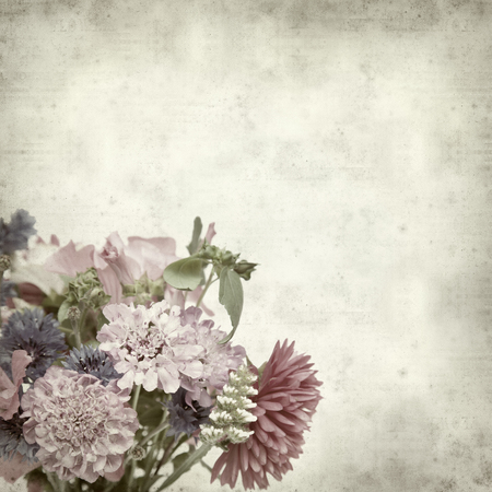 textured old paper background with autumnal posyの写真素材