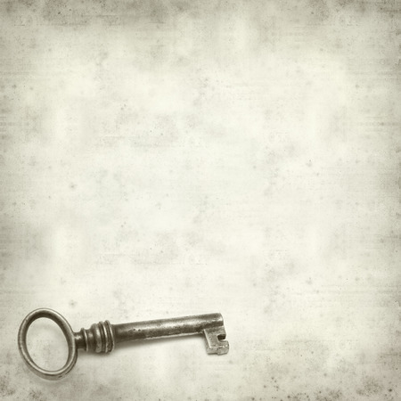textured old paper background with old rusty  keyの写真素材
