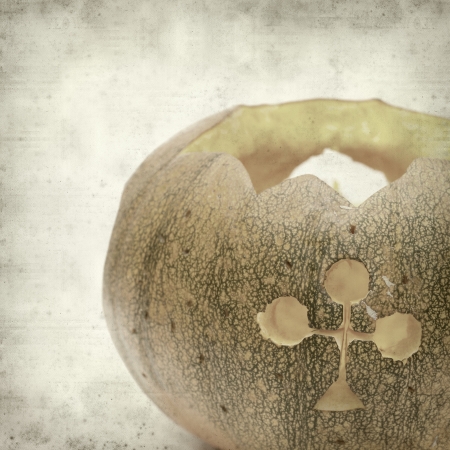textured old paper background with carved pumpkinの写真素材
