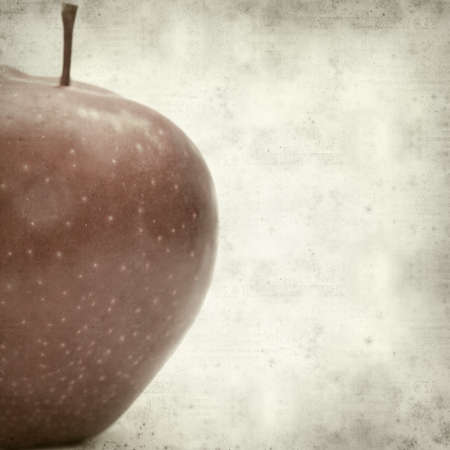 textured old paper background with red appleの写真素材