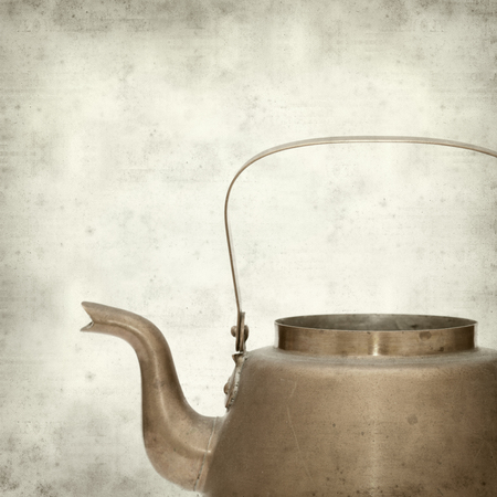 textured old paper background with vintage copper kettleの写真素材