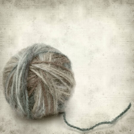 textured old paper background with knitting wool の写真素材