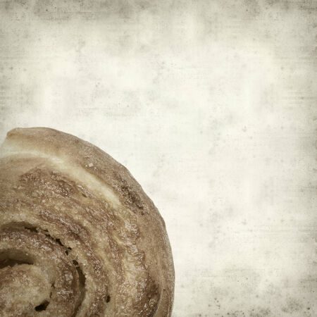 textured old paper background with scandinavian cinnamon bunの写真素材
