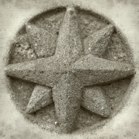 textured old paper background with compass stone reliefの写真素材