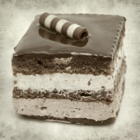 textured old paper background with layer chocolate cakeの写真素材