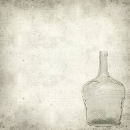 textured old paper background with old glass bottleの写真素材