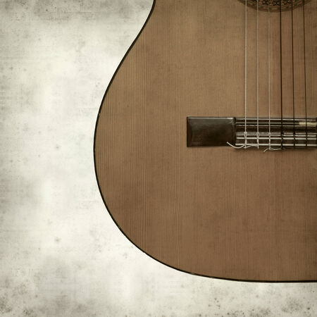 textured old paper background with classic acoustic guitarの写真素材