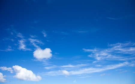 deep blue sky with light clouds backgroundの写真素材