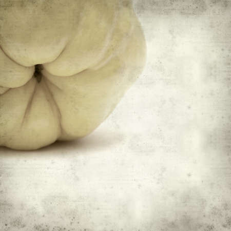 textured old paper background with yellow ripe quince fruitの写真素材