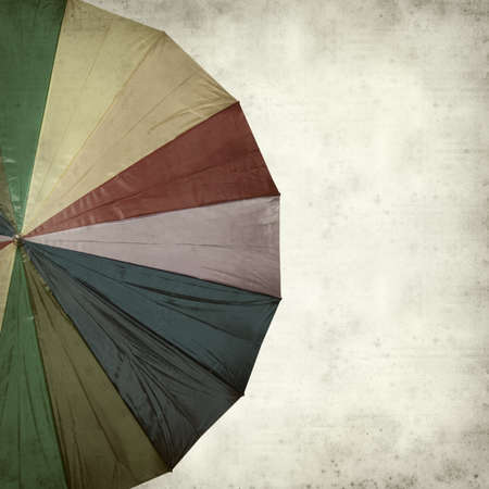 textured old paper background with rainbow umbrellaの写真素材