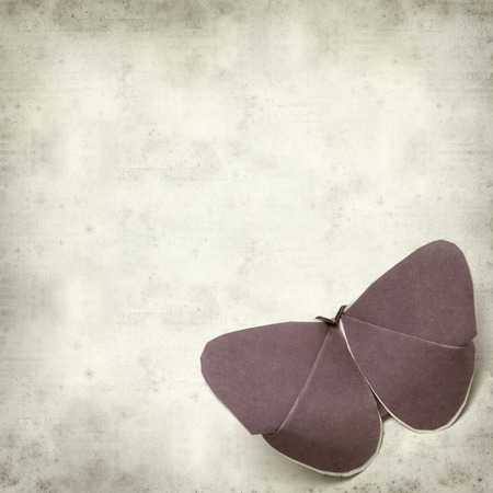 textured old paper background with kirigami butterflyの写真素材