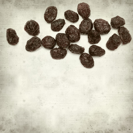 textured old paper background with dried cranberriesの写真素材