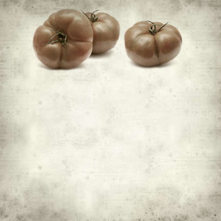 textured old paper background with large red tomatoesの写真素材