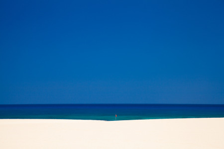Fuerteventura, Burro Beach with red no swimming flag, raising heat melts the air above sandの写真素材