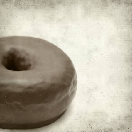 textured old paper background with chocolate glaze donutの写真素材
