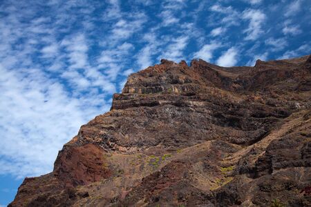La Gomea abstract - tall red rock cliff with rock crystals shaped as "organ pipes"の写真素材