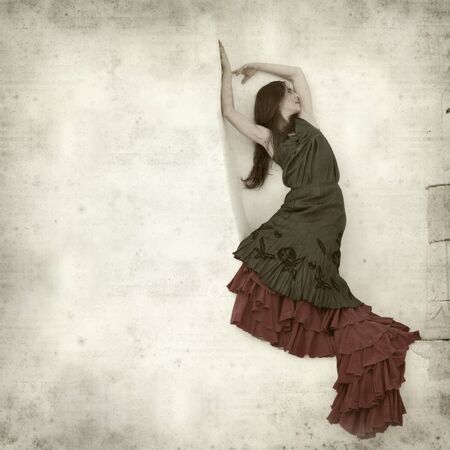 textured old paper background with flamenco dancer in a ruins of old churchの写真素材