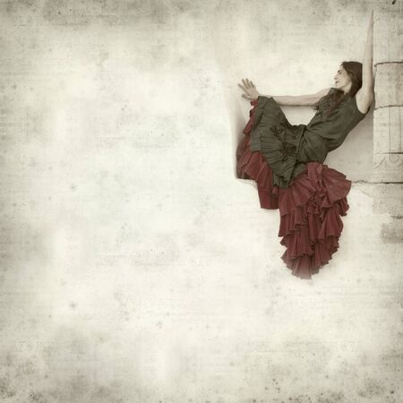 textured old paper background with flamenco dancer in a ruins of old churchの写真素材