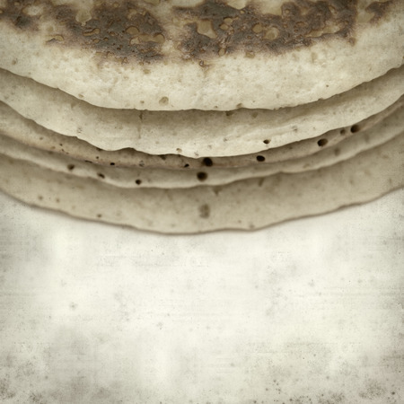 textured old paper background with stacked pancakesの写真素材
