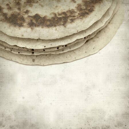 textured old paper background with stacked pancakes