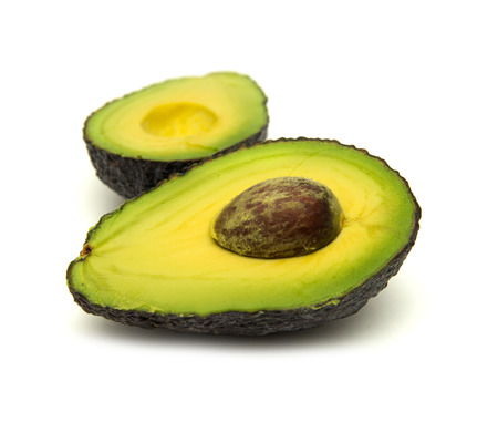 freshly halved avocado pear isolated on white background