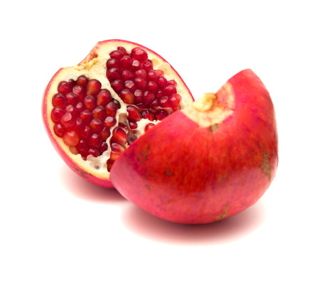 pomegranate fruit split in two, isolated on white backgroundの写真素材