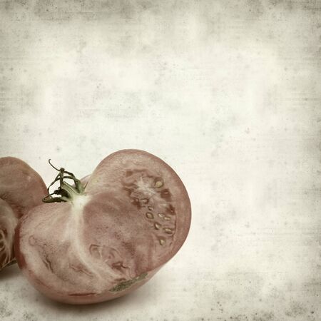 textured old paper background with large tomatoesの写真素材