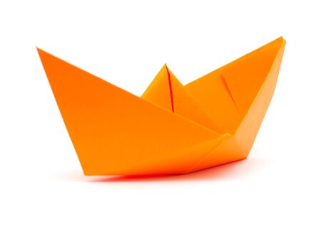 orange origami paper boat isolated on white backgroundの写真素材