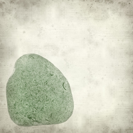 textured old paper background with sea glass piecesの写真素材