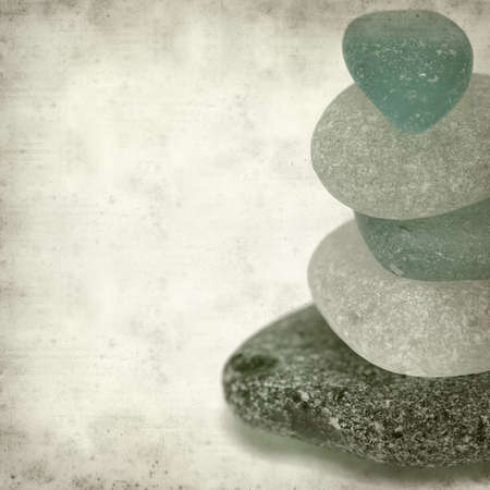 textured old paper background with sea glass pieces in small pyramidの写真素材