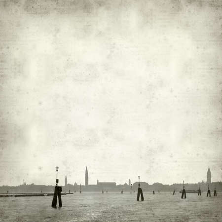 textured old paper background with skyline of Venice, as seen from the seaの写真素材