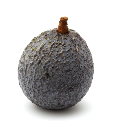 round dark skinned avocado pear isolated on white backgroundの写真素材