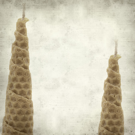 textured old paper background with wrapped beeswax candleの写真素材