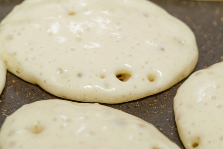 making thick pancakes on dry griddle surfaceの写真素材