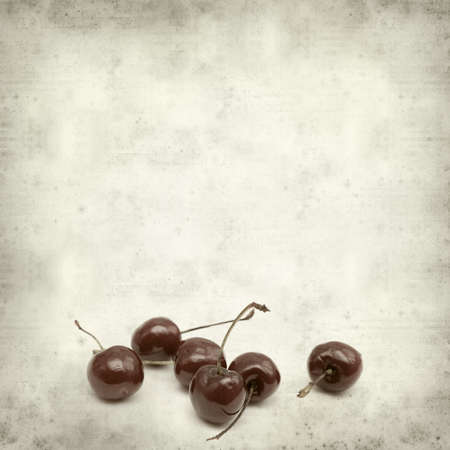 textured old paper background with dark red cherries