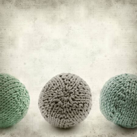 textured old paper background with knitted round ballの写真素材