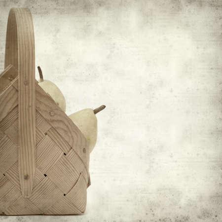 textured old paper background with birch bark basket full of yellow pearsの写真素材