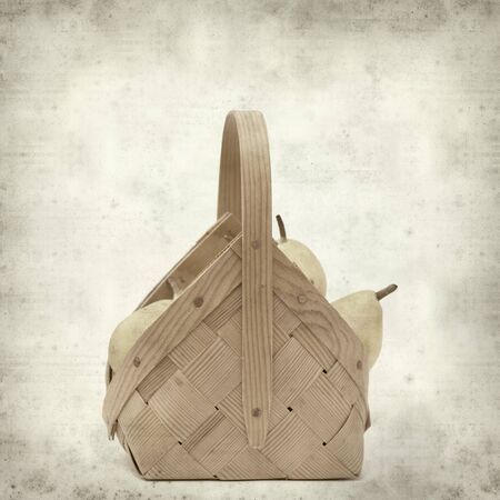 textured old paper background with birch bark basket full of yellow pearsの写真素材