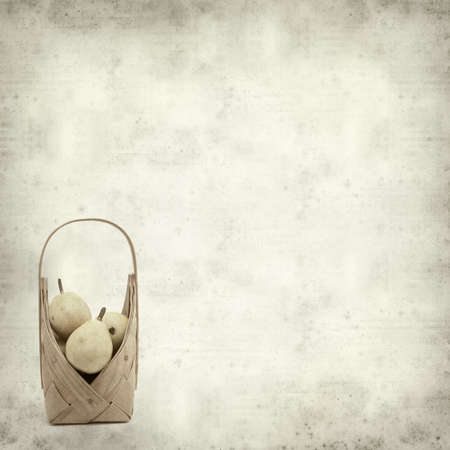 textured old paper background with birch bark basket full of yellow pearsの写真素材