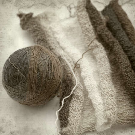 textured old paper background with thin variegated knitting woolの写真素材