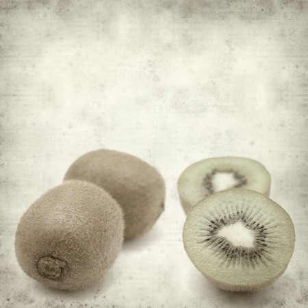 textured old paper background with fresh green kiwifruitの写真素材