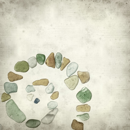textured old paper background with sea glass piecesの写真素材